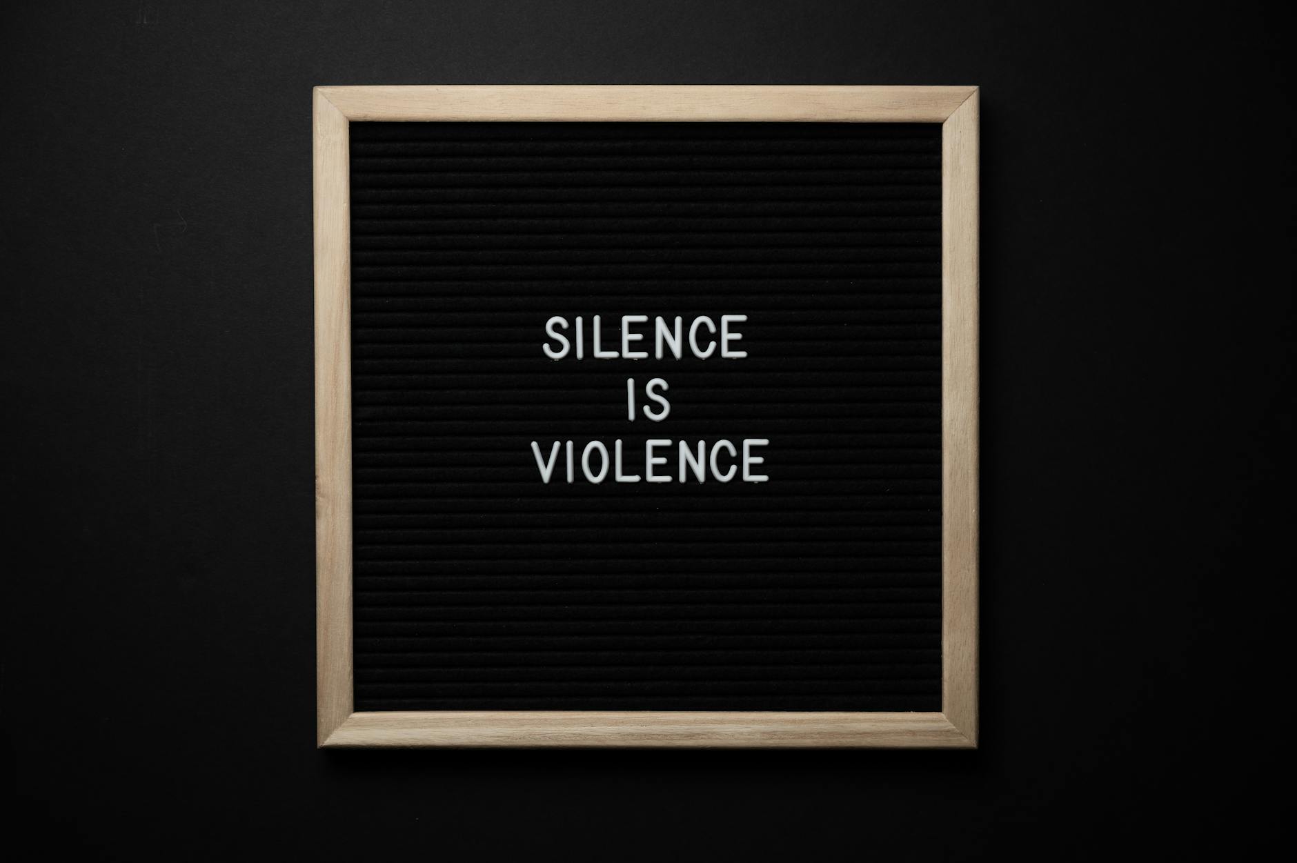 blackboard with silence is violence title on black background